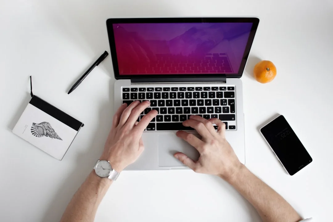Top view of a sleek modern office desk with a laptop, tablet, and accessories.